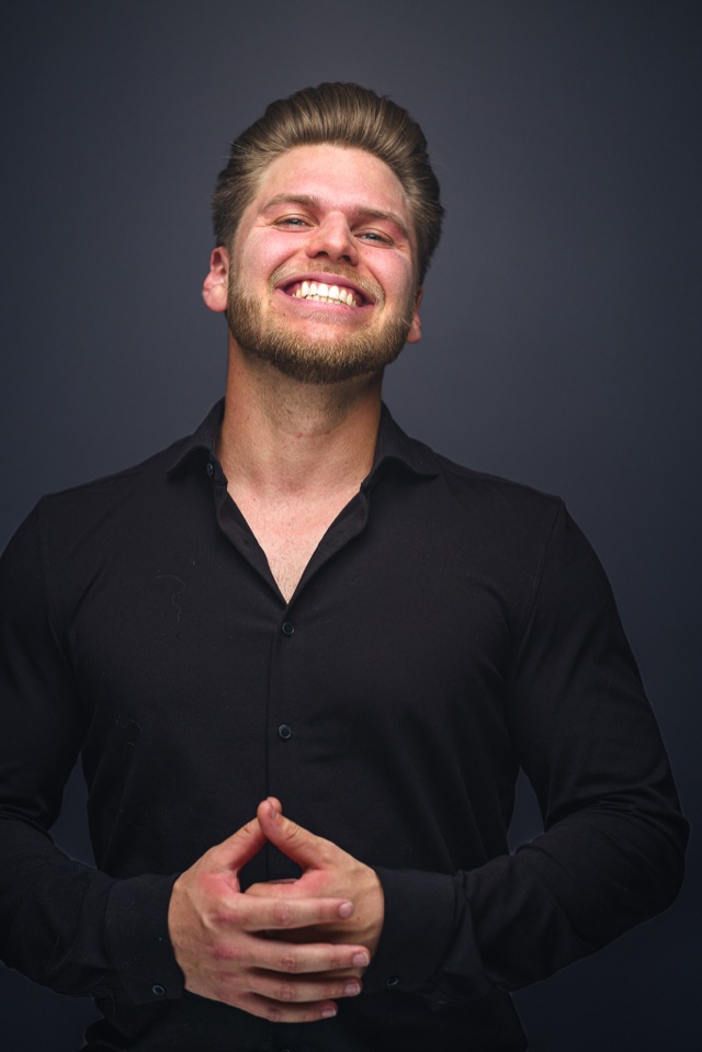 Justin Laule smiling in a black shirt